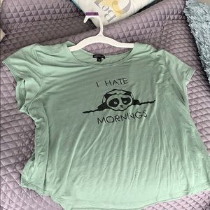 a light green shortsleeved “I Hate Mornings” shirt